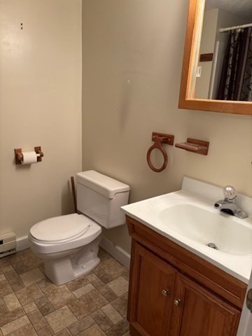 17A Maywood Lane, Unit C Woburn, MA 01801 - Photo 9 of 11 a bathroom with a toilet a sink and mirror
