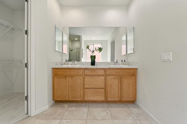 a bathroom with a sink vanity and mirror