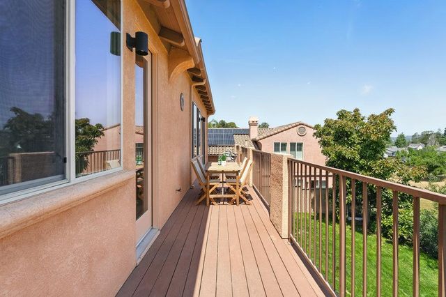 a view of balcony with two chairs and wooden floor