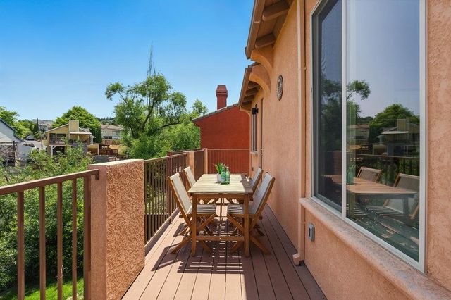 a balcony with table and chairs