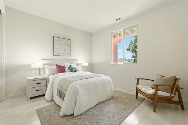 a bedroom with a bed and a chair