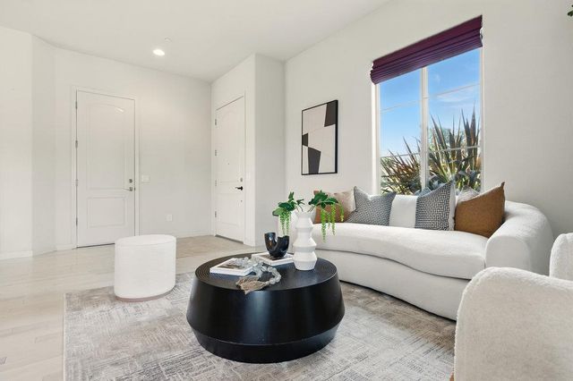 a living room with furniture and a potted plant