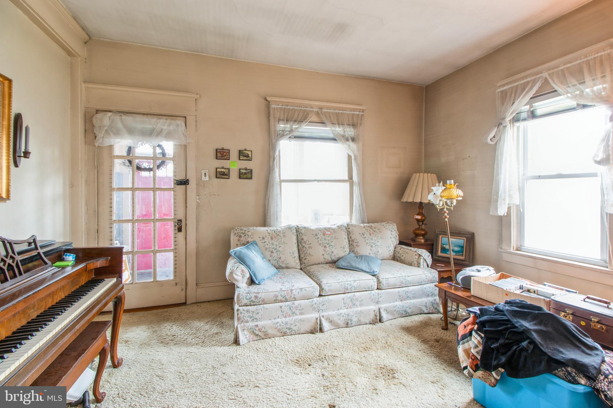 606 Highland Avenue Palmyra, NJ 08065 - Photo 7 of 25 a living room with furniture and a window