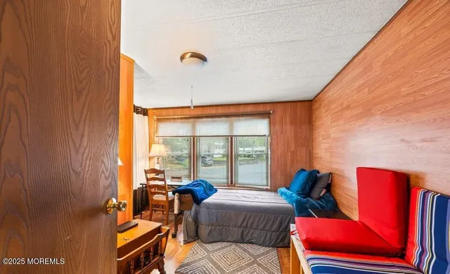 a room with stainless steel appliances kitchen island granite countertop a refrigerator and cabinets