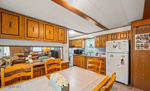 a very nice looking living room with a large window and dining table