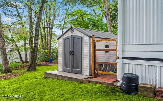 a view of a back yard with a table and chairs
