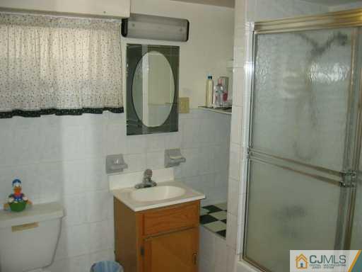 49 Wilcox Road New Brunswick, NJ 08901 - Photo 5 of 8 a bathroom with a sink toilet and shower