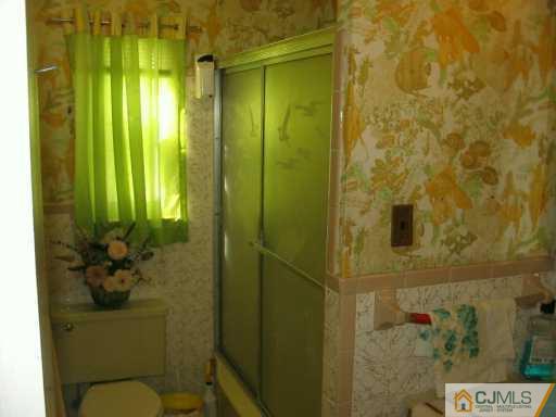 49 Wilcox Road New Brunswick, NJ 08901 - Photo 6 of 8 a bathroom with a shower toilet and sink