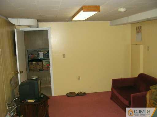 49 Wilcox Road New Brunswick, NJ 08901 - Photo 7 of 8 a bedroom with a bed and furniture