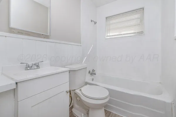 a bathroom with a sink toilet and vanity