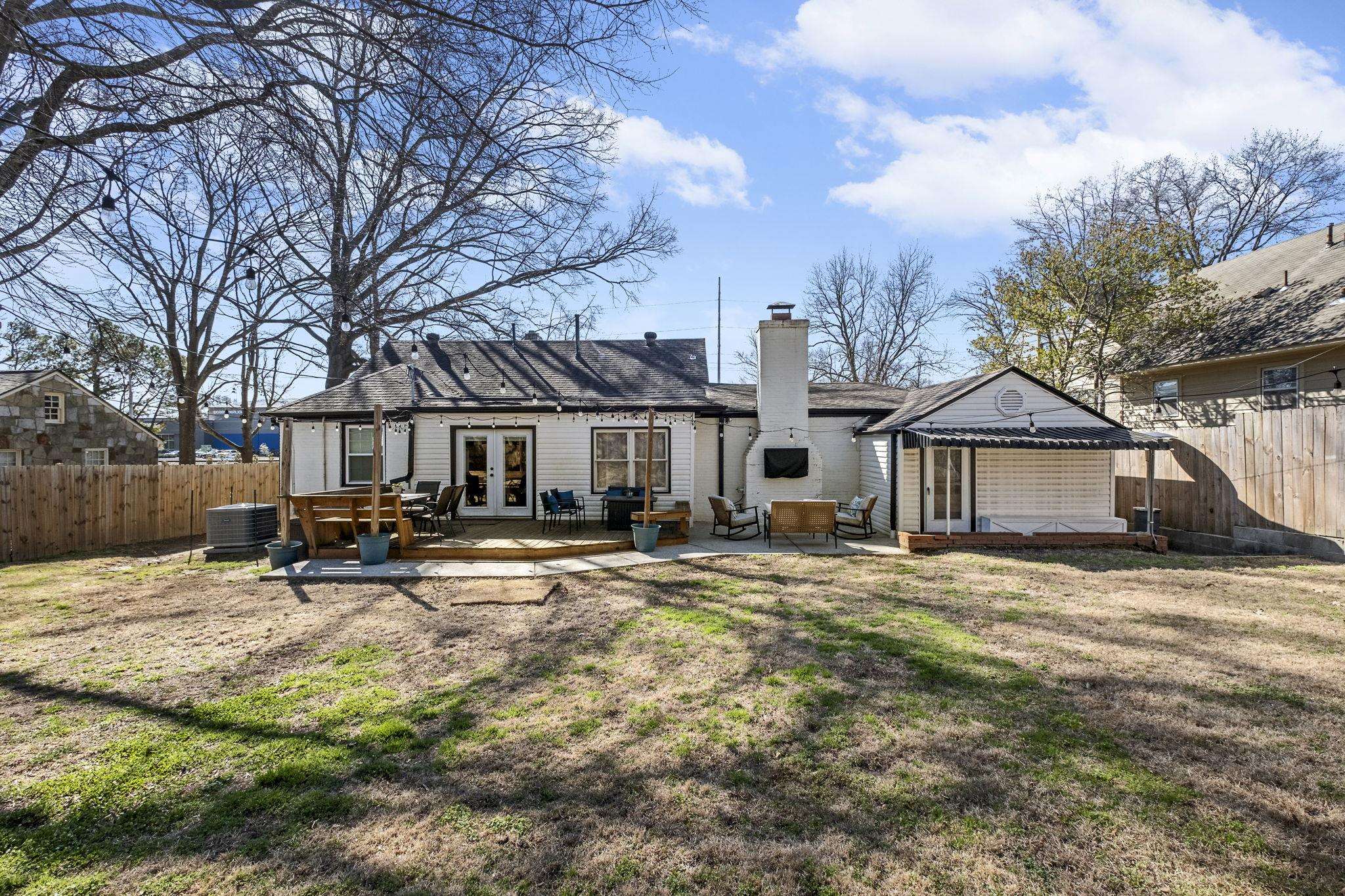 4120 Village Road Memphis, TN 38117 - Photo 27 of 28 Rear view of property featuring french doors, a fenced backyard, a patio, a chimney, and an outdoor living space