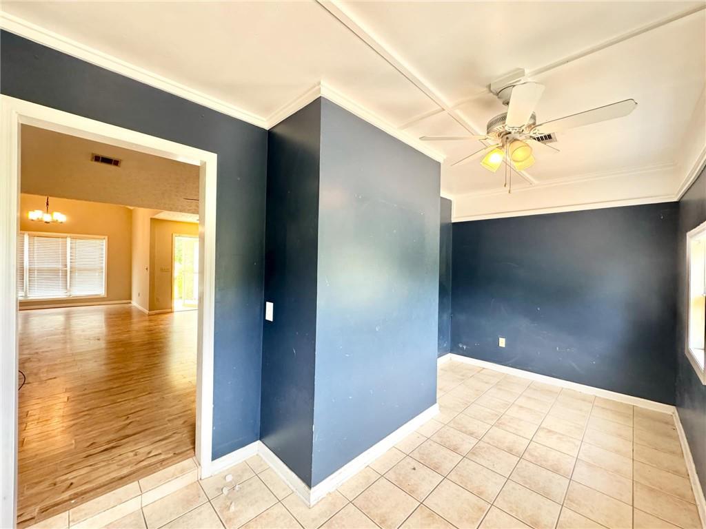 280 Owens Road Fort Mitchell, AL 36856 - Photo 15 of 56 Tiled spare room with a ceiling fan, crown molding, baseboards, and a chandelier