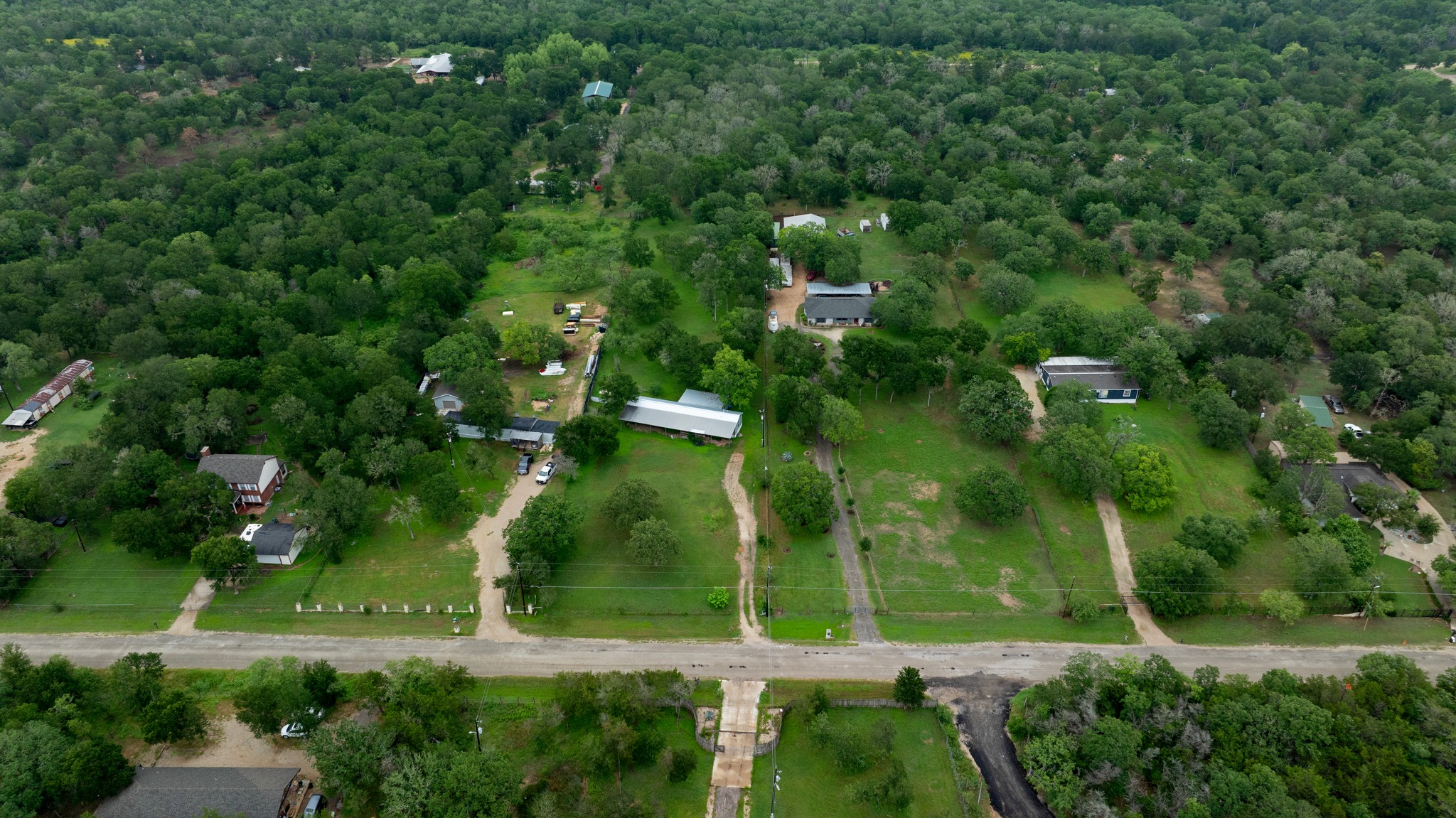 288 The Forest Road Dale, TX 78616 - Photo 28 of 31 an aerial view of residential houses with outdoor space and trees