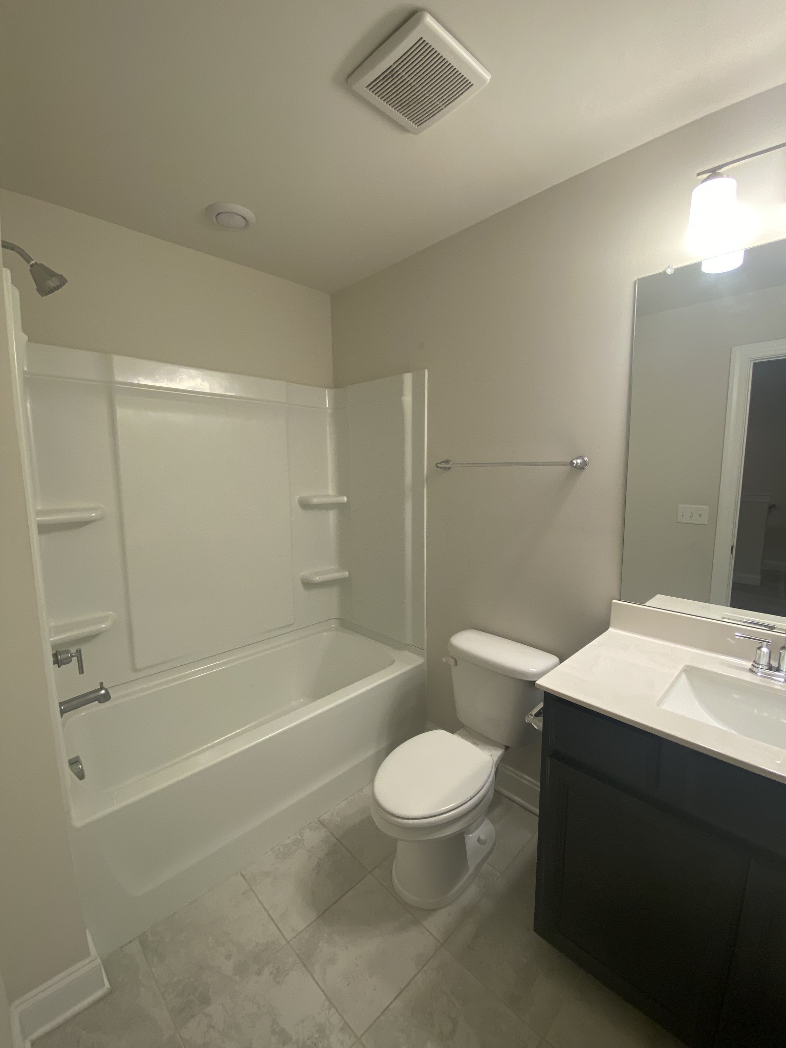 1364 Vilda Way Lebanon, TN 37087 - Photo 14 of 18 a bathroom with a toilet a sink a mirror and bathtub