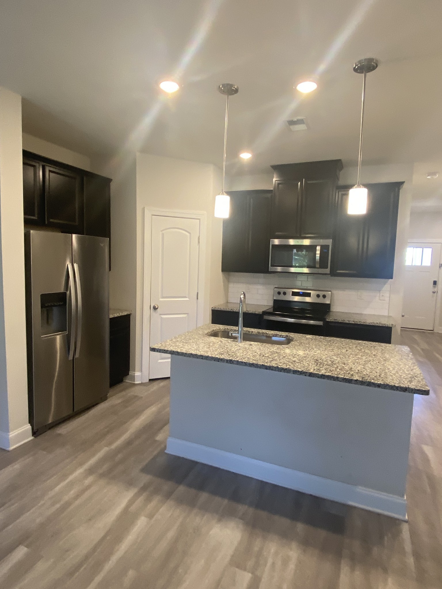 1364 Vilda Way Lebanon, TN 37087 - Photo 6 of 18 a large kitchen with a refrigerator a stove a sink a center island and wooden floor