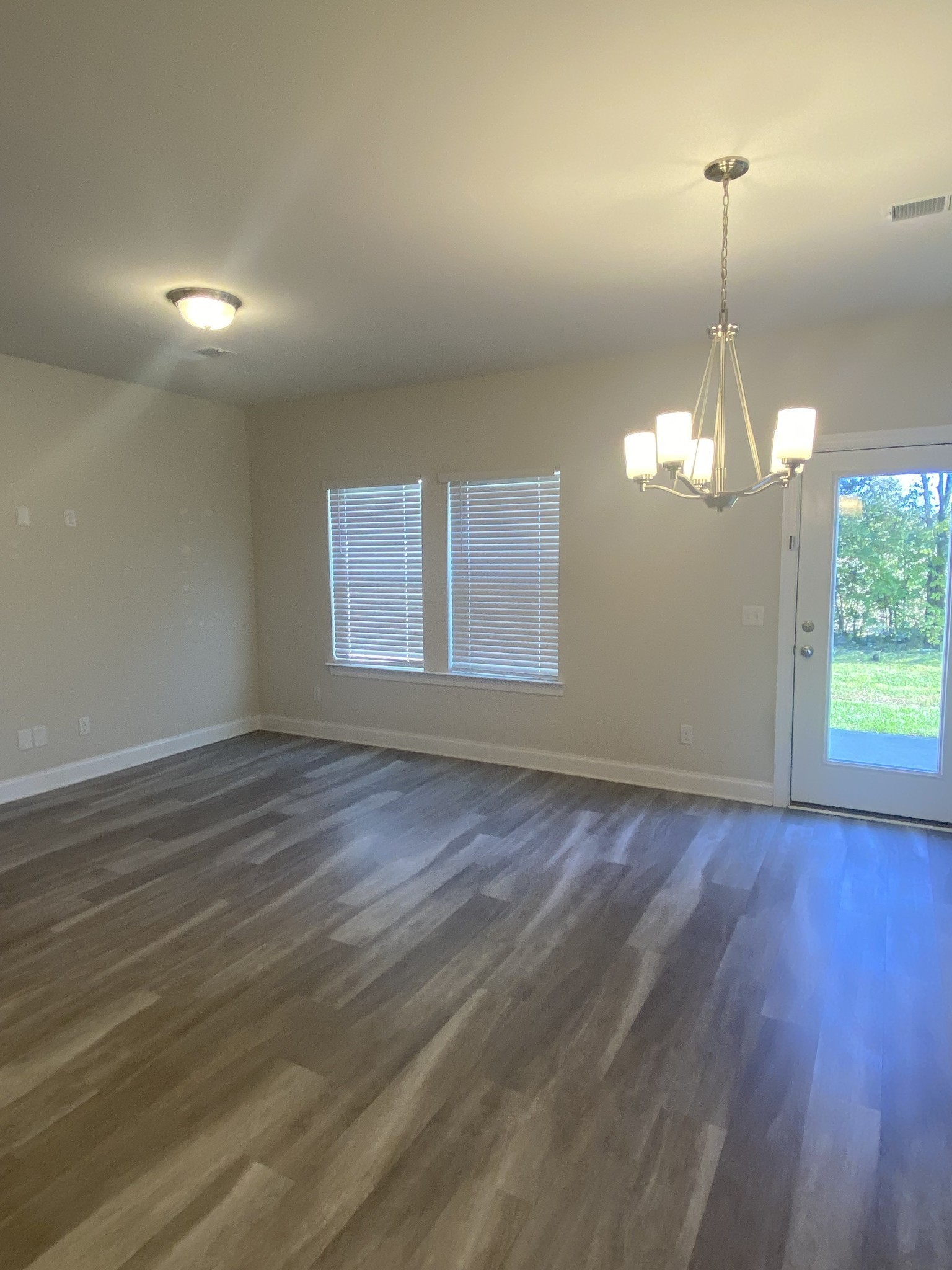 1364 Vilda Way Lebanon, TN 37087 - Photo 8 of 18 an empty room with wooden floor and windows