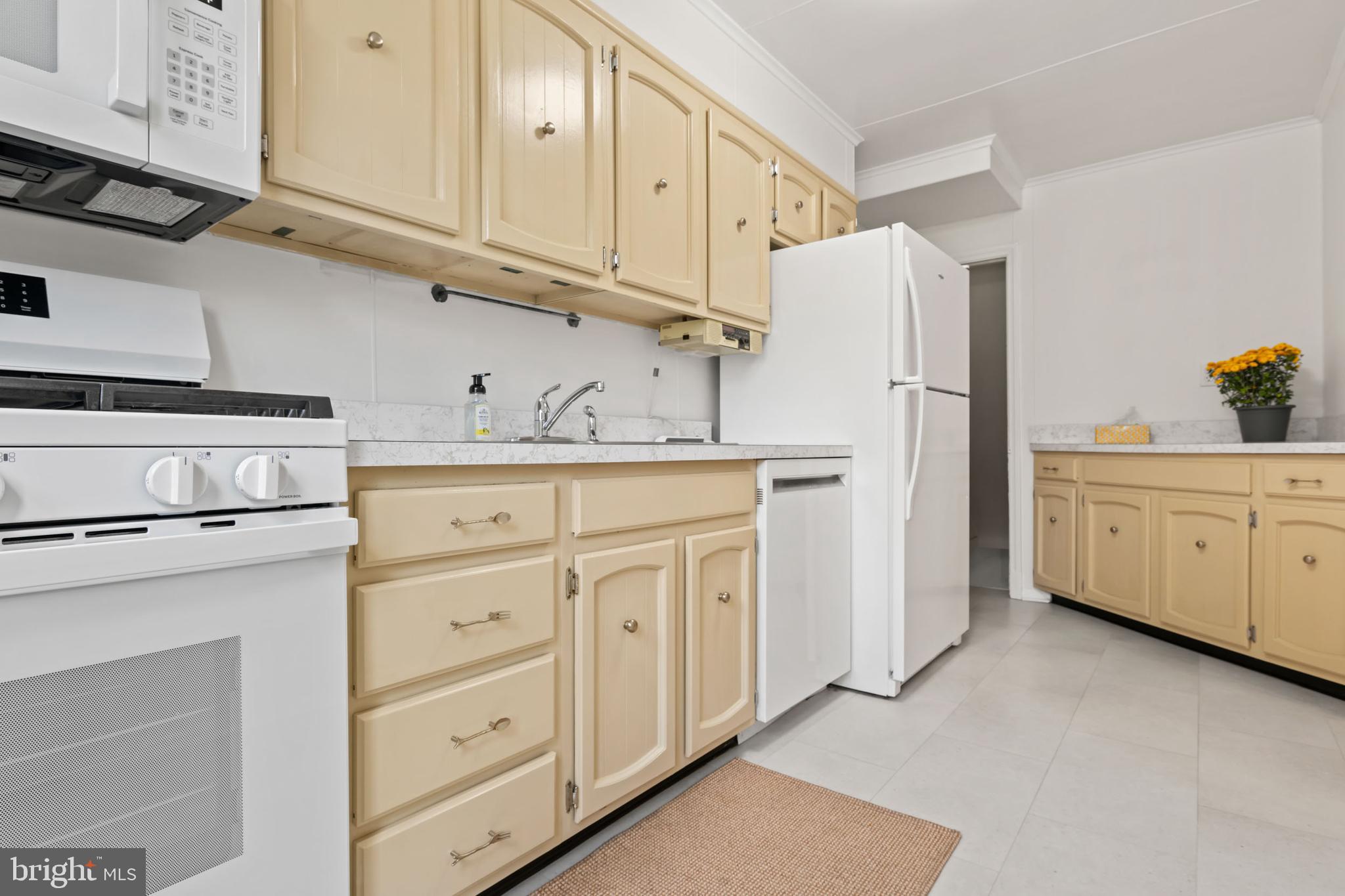 1616 Hardwick Road Towson, MD 21286 - Photo 21 of 53 a kitchen with white cabinets and white appliances