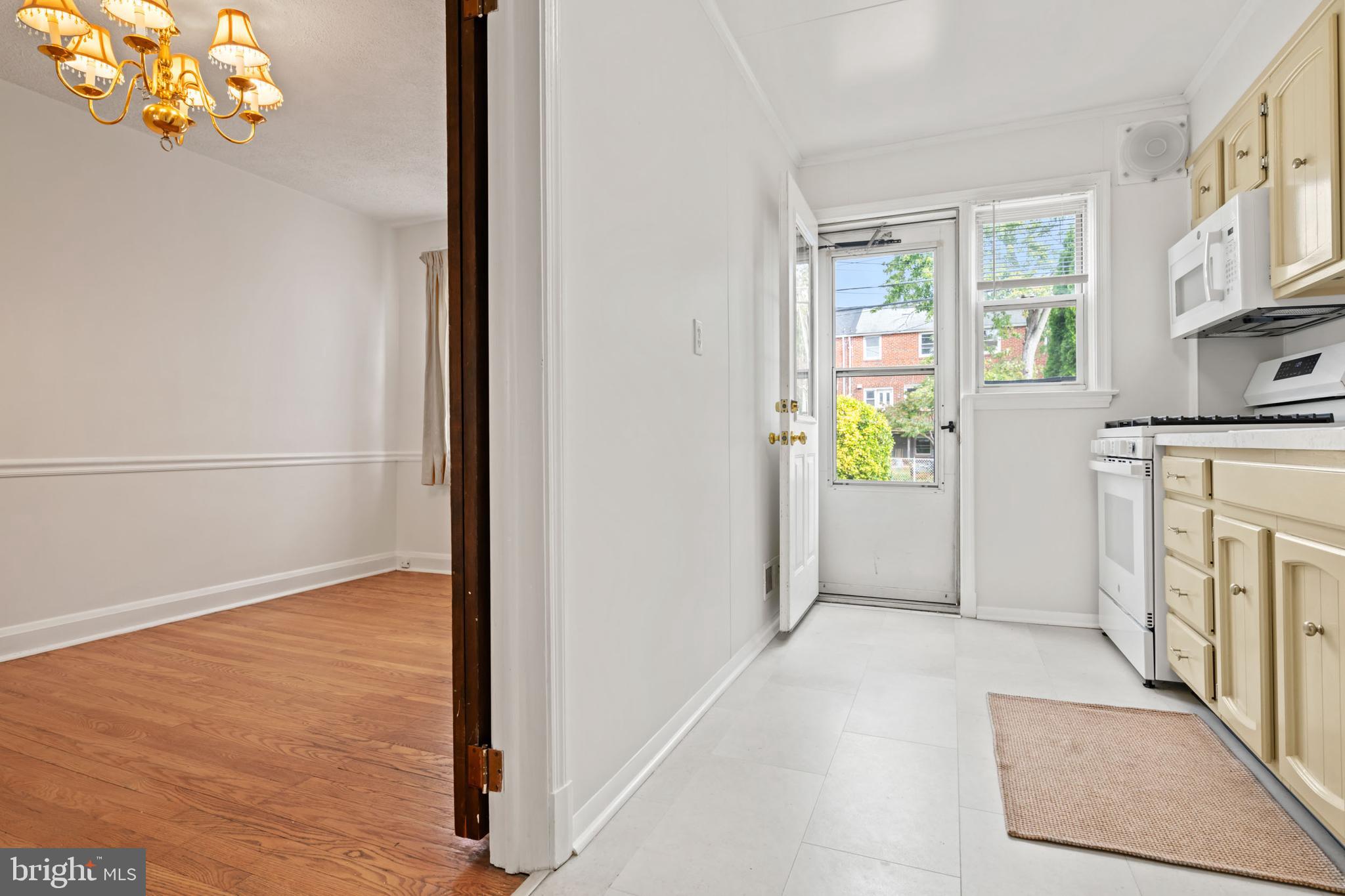 1616 Hardwick Road Towson, MD 21286 - Photo 22 of 53 a view of hallway with chandelier and wooden floor