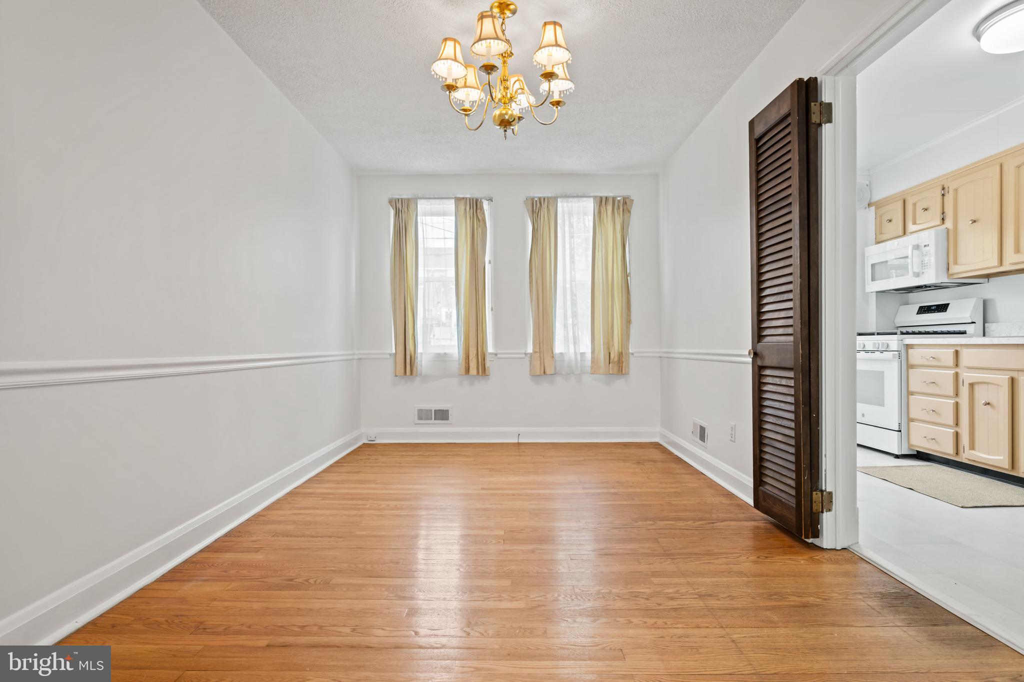 1616 Hardwick Road Towson, MD 21286 - Photo 7 of 53 a view of an empty room with window and wooden floor