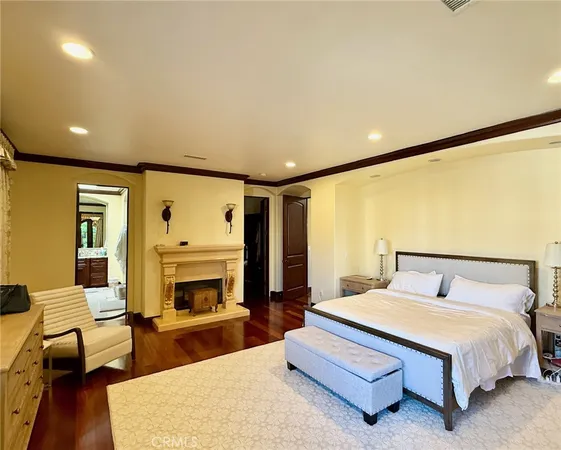 a spacious bedroom with a bed and a fireplace