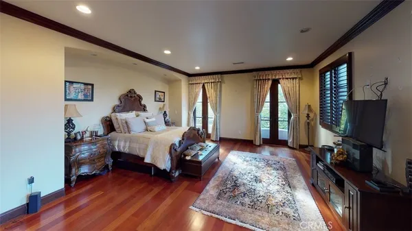 a bed room with a bed and a flat screen tv