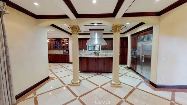 a view of an entryway with a table and chairs in it