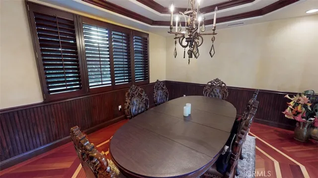 a view of a dining room with furniture and chandelier
