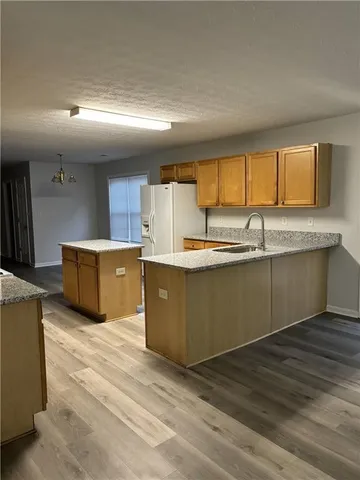 a kitchen with stainless steel appliances granite countertop a sink and cabinets