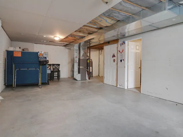 an empty room with furniture and a ceiling fan