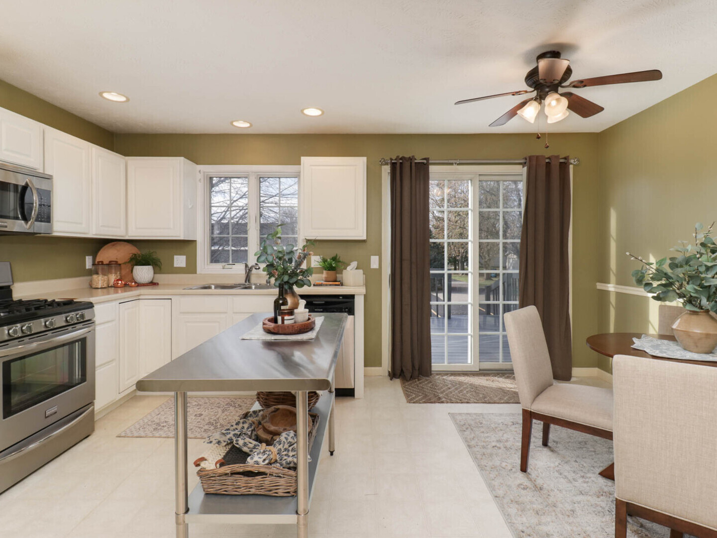 109 Sandra Court Normal, IL 61761 - Photo 6 of 35 a kitchen with stainless steel appliances granite countertop a stove a refrigerator a sink a dining table and chairs with wooden floor