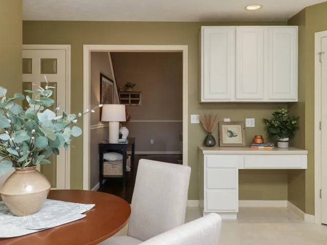 a living room with furniture and a potted plant