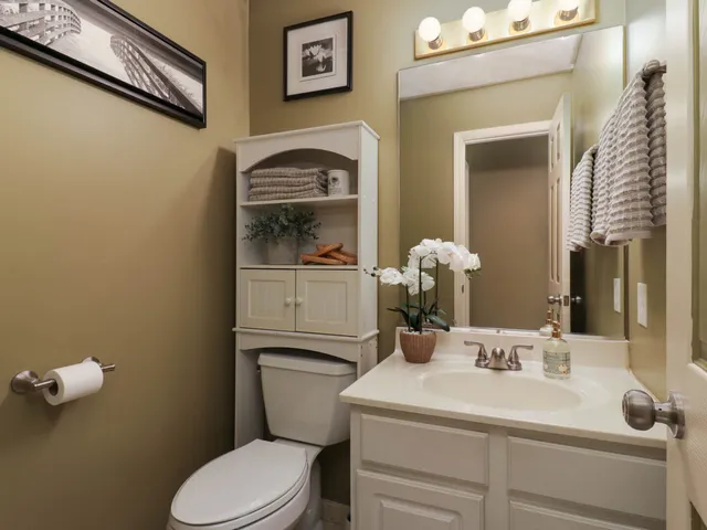 a bathroom with a toilet a sink and mirror