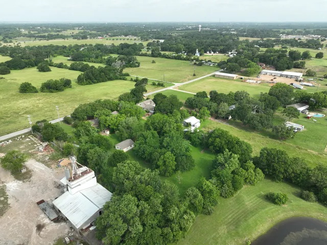 an aerial view of a house with a yard