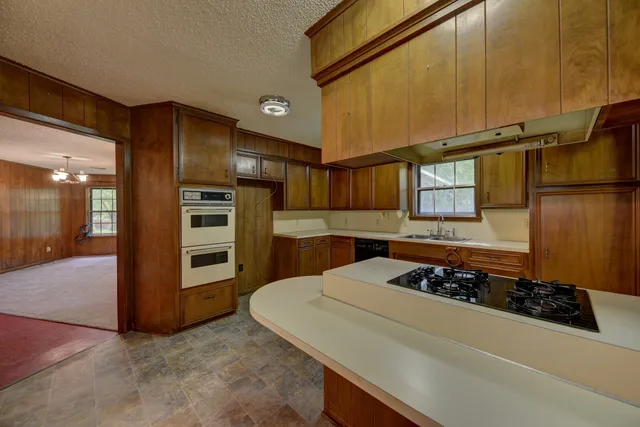 a kitchen with stainless steel appliances granite countertop a stove and a refrigerator