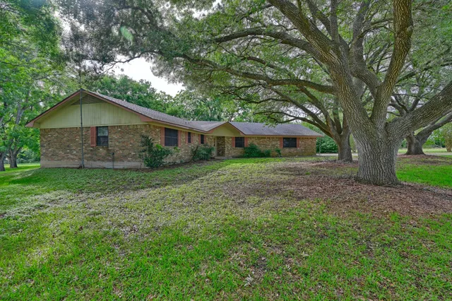a view of a house with yard and green space