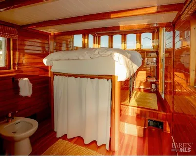 a living room with furniture and a book shelf