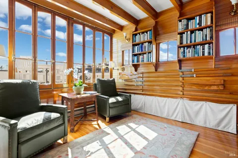 a living room with furniture and a book shelf
