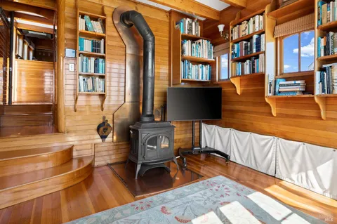 a view of walk in closet with clothes and window