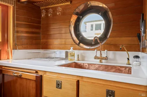 a room with wooden cabinets and stainless steel appliances