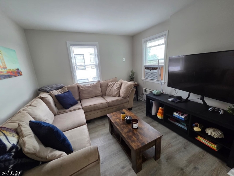166 Carmita Avenue Rutherford, NJ 07070 - Photo 7 of 27 a living room with furniture a flat screen tv and a window