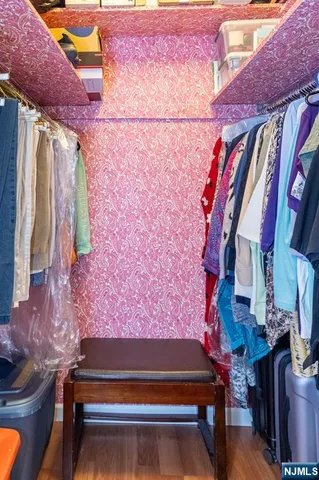 a view of walk in closet with clothes