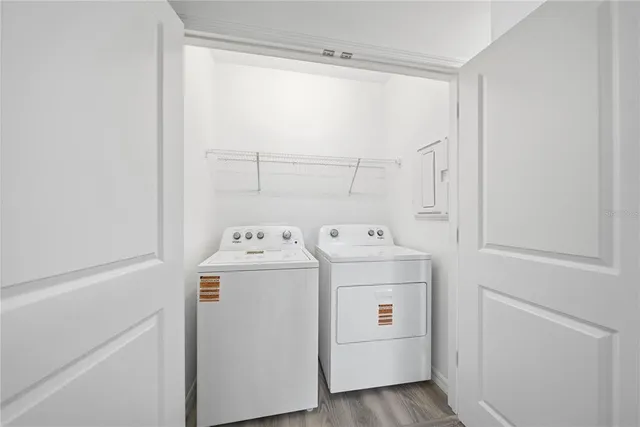 an aerial view of residential houses with outdoor space and lake view