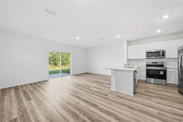a view of kitchen with microwave and cabinets