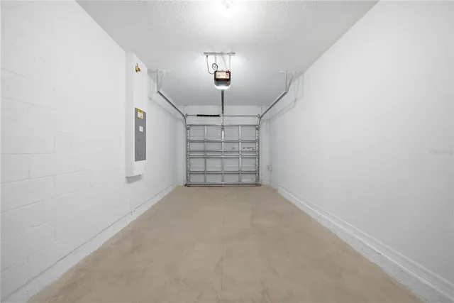 an empty room with windows and trees