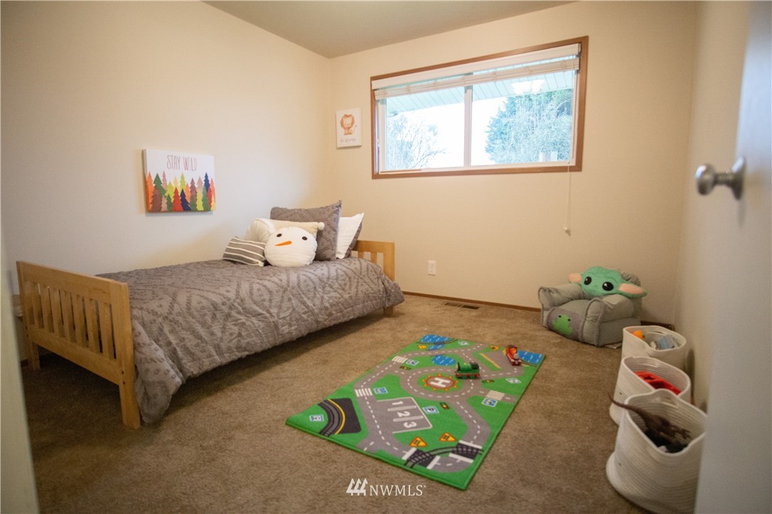 306 216th Street Southwest Bothell, WA 98021 - Photo 19 of 31 a bedroom with a bed and a couch