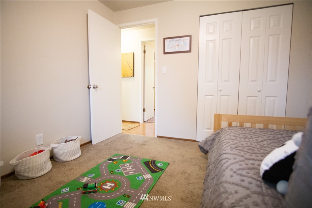 306 216th Street Southwest Bothell, WA 98021 - Photo 20 of 31 a bedroom with a bed and a table in it