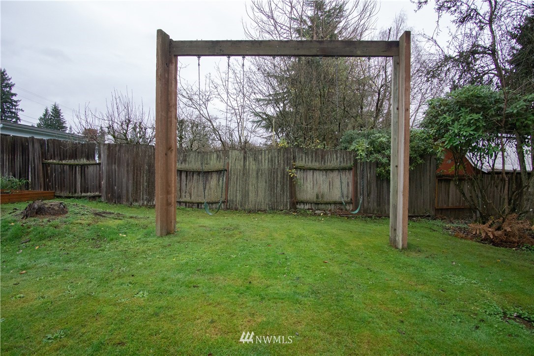 306 216th Street Southwest Bothell, WA 98021 - Photo 28 of 31 a backyard of a house with plants and wooden fence