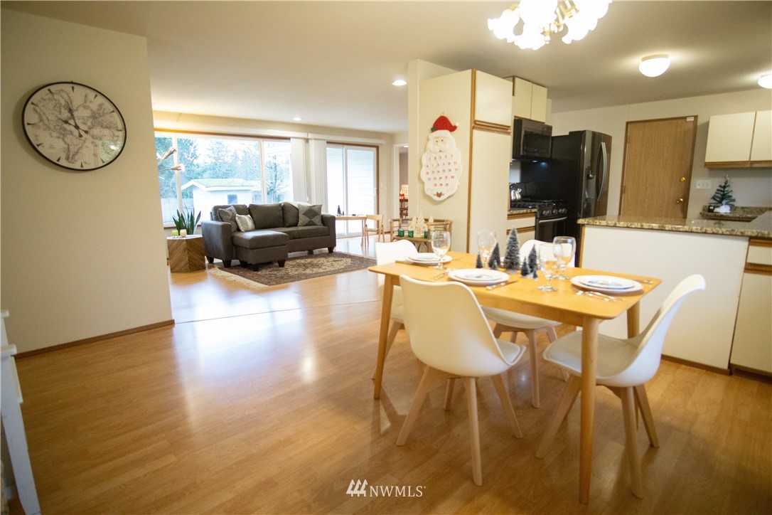 306 216th Street Southwest Bothell, WA 98021 - Photo 3 of 31 a living room with furniture a large window and wooden floor