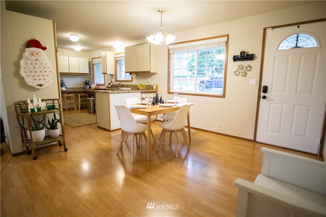 306 216th Street Southwest Bothell, WA 98021 - Photo 4 of 31 a view of a dining room with furniture window and wooden floor