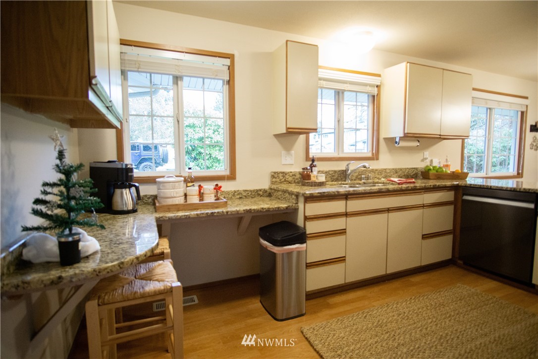 306 216th Street Southwest Bothell, WA 98021 - Photo 6 of 31 a kitchen with a sink stove and cabinets